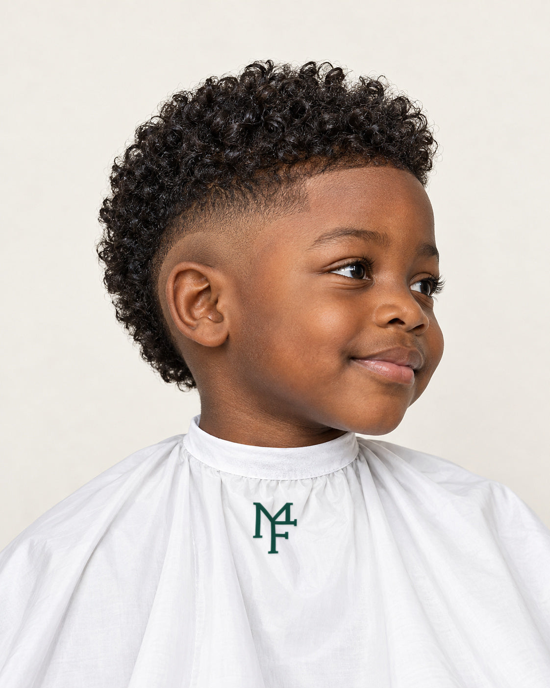 Illustration of a young boy with a curly top and burst fade, wearing a white cape with the emerald Miami Fades crest