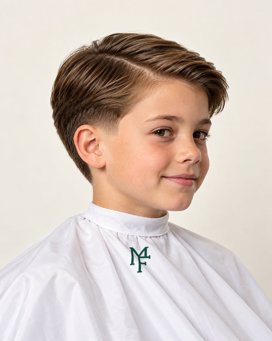 Illustration of a child with a side part and taper fade, wearing a white cape with the emerald Miami Fades crest