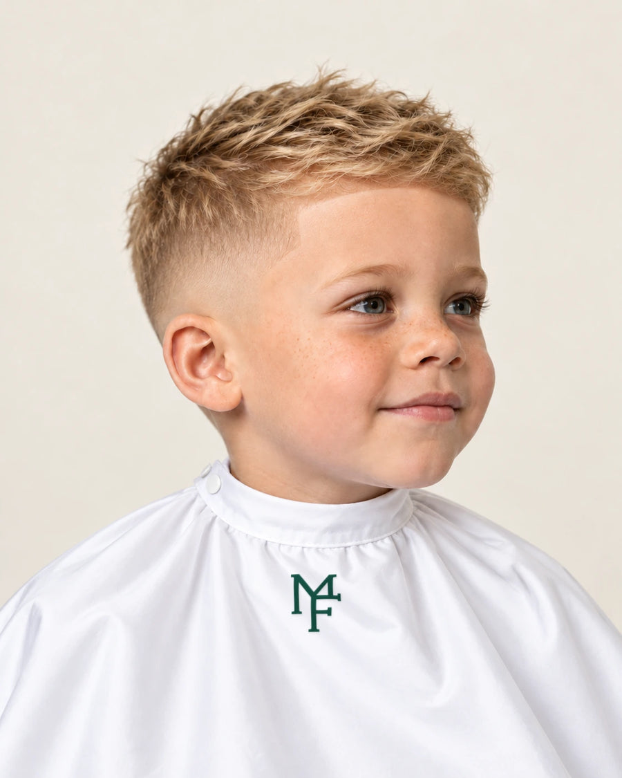 Illustration of a child with a skin fade, wearing a white cape with the emerald Miami Fades crest